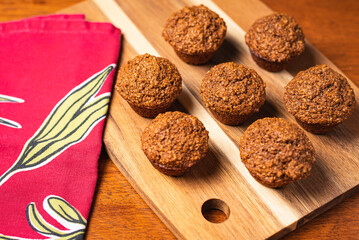 Vegetarian bran muffins on wood tray with red napkin
