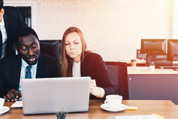 Business team looking at computer screen. 