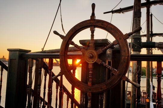 Ancient wooden rudder on board ship at sunrise - Slnecne jazera, Senec, Slovakia, Europe