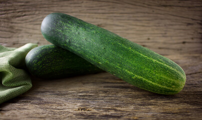 Fresh cucumber on rustic wooden background.