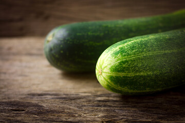 Fresh cucumber on rustic wooden background.