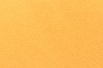 Fototapeta na wymiar Light brown cardboard texture. Uniform beige background with small inclusions.