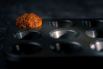 Spotlight on single homemade muffin in cooking tray