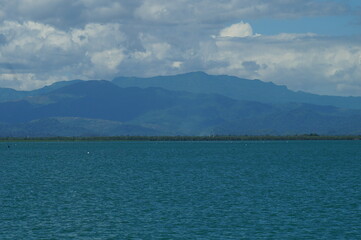 A view of the blue sea against a mountain backdrop
