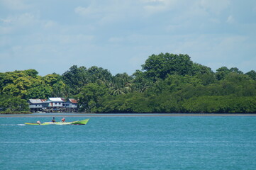 view of blue sea by boat and island during daytime