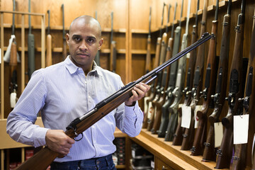 Seller demonstrates a combat winchester in the gun store