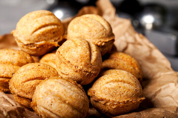 Chriatmas food. Shortbread russian walnut shaped cookies Oreshki with caramel.Close-up