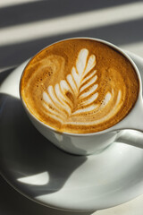 cup of coffee latte art with window light