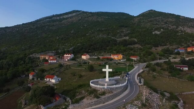 Aerial footage of a large white cross that looks out over the valley.