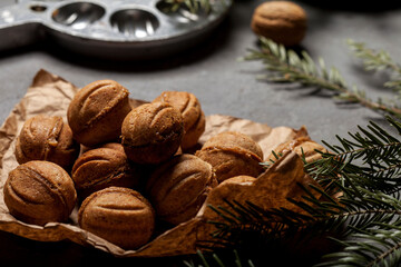 Nuts with condensed milk on the background of a walnut-shaped cookie pan, making walnut-shaped shortbread cookies, homemade cookies, dessert, making sweets