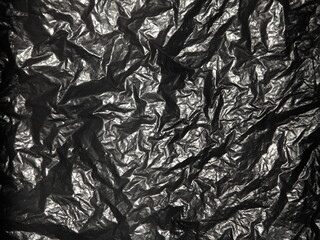 Jammed black polyethilene film surface,  crumpled background texture