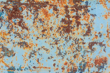 Blue rusted metal background. A rusty and scratched painted metal wall. Rusty metal background with streaks of rust .