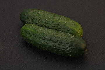 Green fresh cucumbers over background