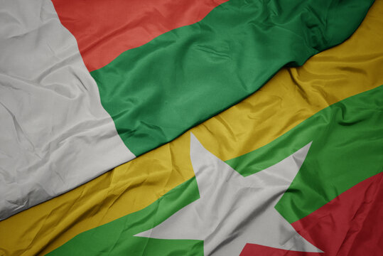 waving colorful flag of myanmar and national flag of madagascar.