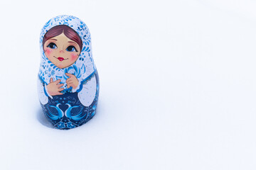 Hand-painted nesting doll on a snowy background.