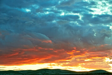 Evening cloudy sky over the sand dunes.