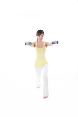 Portrait of young woman exercising with dumbbell