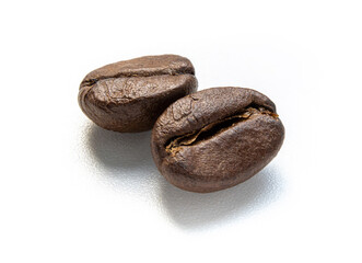 Closeup dark brown coffee beans isolated on white background. Top view. Flat lay. Macro