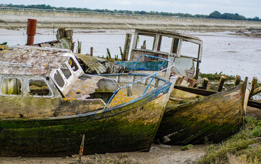 Vendée, France; January 15, 2021: Prows of old abandoned boats in the boat cemetery of the island of Noirmoutier.