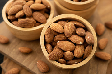 Bowl with almond on a wooden table. (selective focus; close-up shot)