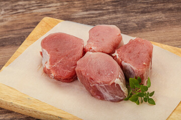 Raw pork medallion served rosemary