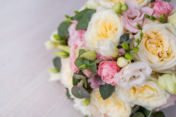 close-up of a beautiful bouquet on a gray background. Soft pink roses and cream, yellow