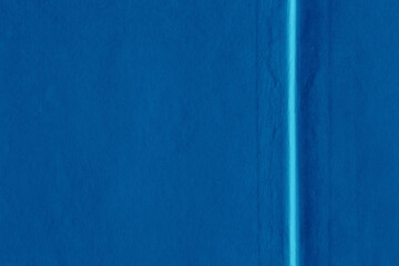 Cardboard blue abstract pattern texture close-up. Retro old paper background. Grunge concrete wall. Vintage blank wallpaper.