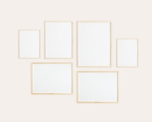Six vertical and horizontal wooden frames on wall, gallery wall for photo, art, design presentation, frame mockup, soft pink background.