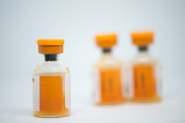 Closed up injection medicine vial on white