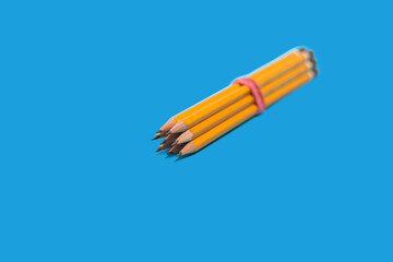 pencils lying on a blue background