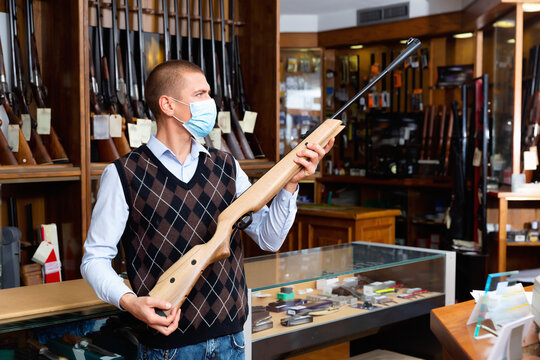 Seller demonstrates a combat winchester in the gun store