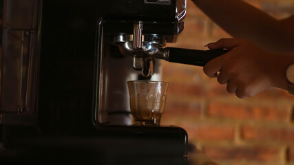 espresso shot from coffee machine make by barista in coffee shop cafe