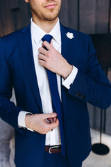 Portrait of the groom. The groom is preparing to meet the bride. Photoshoot of a successful businessman.

