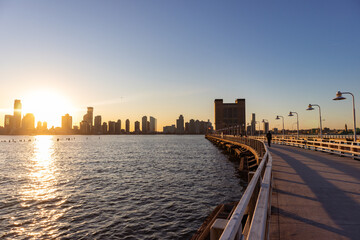Pier 34 along the Hudson River in New York City with a Sunset over the Jersey City Skyline