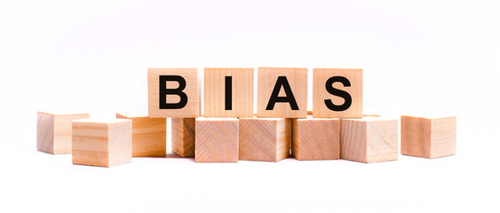 On a light background, wooden cubes with the text BIAS