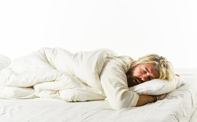 Early morning. Carefree guy in deep sleep. good morning routine. Caucasian bearded guy wearing white bathrobe. relax in a hotel room in a robe. bearded mature man lying on bed at home