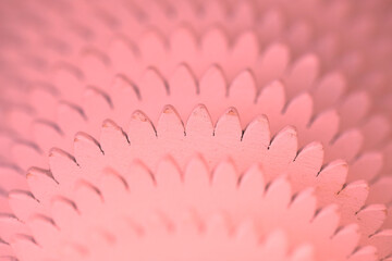 Light pink background. Abstraction. Concentric wooden circles similar to gears.