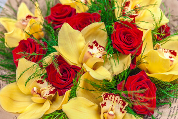 Bouquet of red roses and yellow orchids