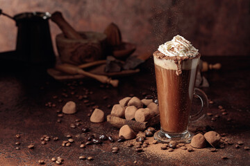 Truffles and glass of hot chocolate with whipped cream.