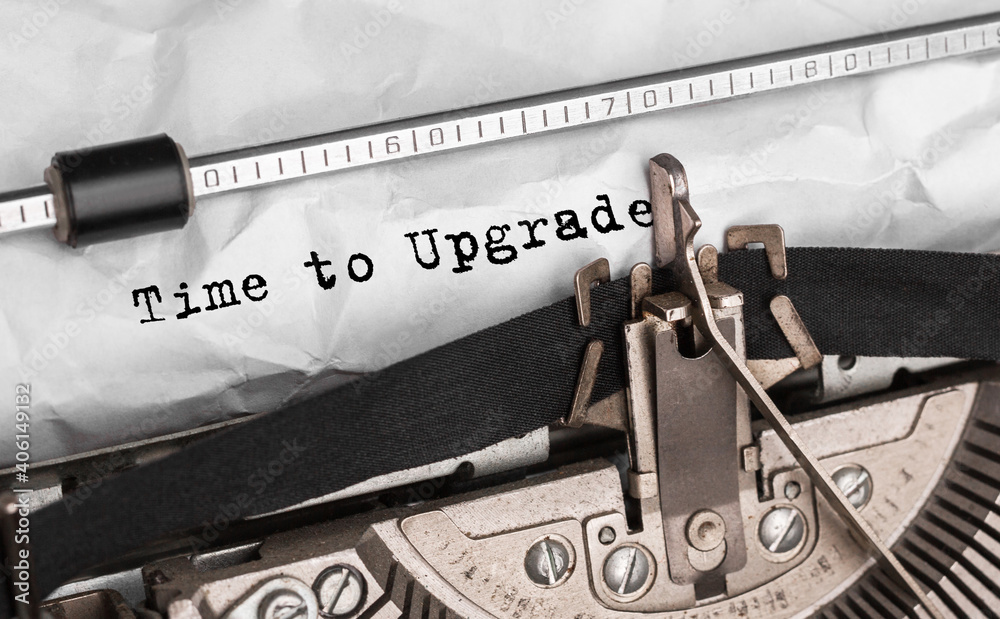 Poster text time to upgrade typed on retro typewriter