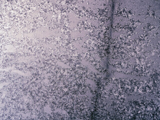 Frosty winter patterns on window glass. Close-up.