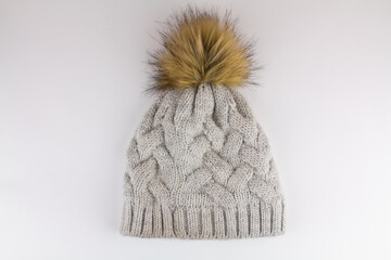 beautiful knitted winter hat on a white background