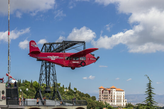 Red airplane propeller carousel attraction at Tibidabo Amusement Park. Barcelona, Spain, August 26, 2012