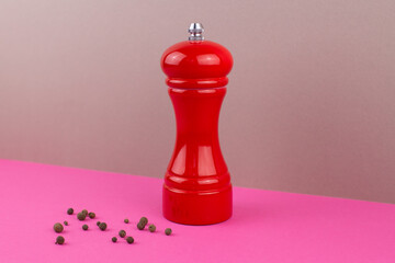red kitchen pepper shaker for ground pepper on the table