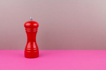 red kitchen pepper shaker for ground pepper on the table