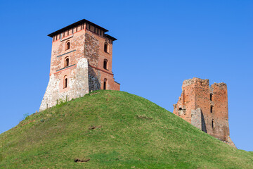 Fototapeta na wymiar Ruins of towers of medieval castle on a sunny April day. Novogrudok, Belarus