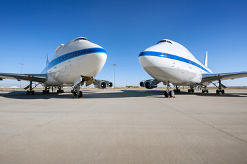 Airplane parking on an airport runway in sunny day . Elements of this image furnished by NASA