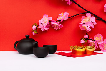 Sakura Cherry Blossom, Black Chinese Teapot and Glass Golden Ingot and Red Envelope on White and Red Backgrounds