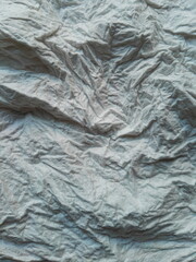 Embossed surface of crumpled paper towel texture.
