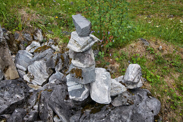 pyramid of stones on a block of stone in the forest.